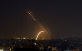 Illustrative: Rockets are launched from the Gaza Strip toward Israel, November 13, 2019. (AP Photo/Khalil Hamra)