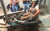 Neria Zarog attaches himself to a saw machine in Yitzhar to avoid arrest for violating an administrative order on November 10, 2019. (Honenu)