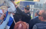 MK Ahmad Tibi (2nd right) is guarded by a policeman as he arrives at a speaking engagement in Ramat Hasharon, November 30, 2019 (Channel 12 video screenshot)