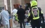 Medics evacuate a man who lit himself on fire in a Beersheba court on November 10, 2019 (screen capture via Twitter)
