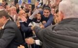 Prime Minister Benjamin Netanyahu shaking hands with supporters outside his official residence in Jerusalem on November 23, 2019. (screen capture: Twitter)