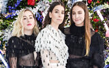 The Haim sisters, from left, Alana, Danielle and Este, of the group Haim at Rodarte's fashion week show in San Marino, California, February 5, 2019. (Presley Ann/Patrick McMullan via Getty Images/via JTA)