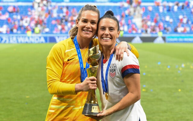 US women's national team players Ashlyn Harris, left, and Ali Krieger pose with the World Cup trophy after winning the tournament at Stade de Lyon in Lyon, France, July 7, 2019. (Brad Smith/isiphotos.com/Getty Images via JTA) US women's national team players Ashlyn Harris, left, and Ali Krieger pose with the World Cup trophy after winning the tournament at Stade de Lyon in Lyon, France, July 7, 2019. (Brad Smith/isiphotos.com/Getty Images via JTA)