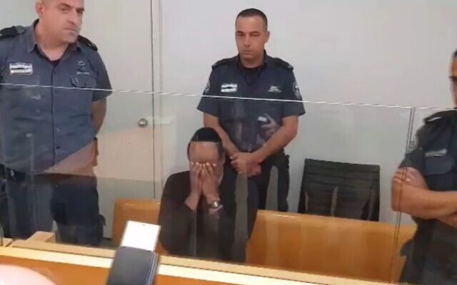 Atrisaw Aynalem arrives at the Haifa District Court on November 25, 2019 where he was charged with the murder of his estranged wife Sifrash last year. (screen capture: Channel 12) Atrisaw Aynalem arrives at the Haifa District Court on November 25, 2019 where he was charged with the murder of his estranged wife Sifrash last year. (screen capture: Channel 12)