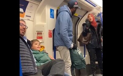 A Muslim woman (R) is seen trying to stop a man (C) from shouting anti-Semitic abuse at Jewish family with small children on the London Underground on November 22, 2109 (Screencapture/Twitter) A Muslim woman (R) is seen trying to stop a man (C) from shouting anti-Semitic abuse at Jewish family with small children on the London Underground on November 22, 2109 (Screencapture/Twitter)