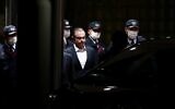 Former Nissan chairman Carlos Ghosn (C) is escorted as he walks out of the Tokyo Detention House following his release on bail in Tokyo on April 25, 2019. (Behrouz MEHRI / AFP)