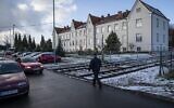 A man walks by the State High School of Oswiecim, located in what used to be SS troops's residential building, in Oswiecim, Poland, on December 3, 2019. (Photo by Wojtek RADWANSKI / AFP)