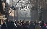 Visitors enter through the main gate with the inscription "Arbeit macht frei" (literally in English: "work makes (one) free") at the entrance to the Auschwitz German Nazi death camp ahead of German Chancellor Angela Merkel's landmark visit in Oswiecim, Poland, on December 5, 2019. (JANEK SKARZYNSKI / AFP)