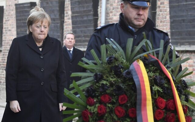 German Chancellor Angela Merkel lays a wreath at the Death Wall during her visit at the former German Nazi death camp Auschwitz-Birkenau in Oswiecim, Poland on December 6, 2019. (John Macdougall/AFP)
