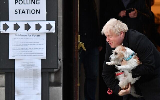 Britain's Prime Minister Boris Johnson poses with his dog Dilyn as he leaves from a polling station in central London on December 12, 2019, as Britain holds a general election. (Daniel Leal-Olivas/AFP) Britain's Prime Minister Boris Johnson poses with his dog Dilyn as he leaves from a polling station in central London on December 12, 2019, as Britain holds a general election. (Daniel Leal-Olivas/AFP)