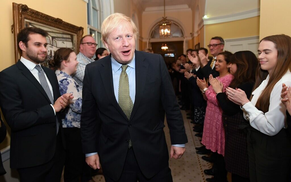 Britain's Prime Minister and Conservative Party leader Boris Johnson is greeted by staff as he arrives back at 10 Downing Street in central London on December 13, 2019, following an audience with Britain's Queen Elizabeth II at Buckingham Palace, where she invited him to become prime minister and form a new government. (Stefan Rousseau/POOL/AFP) Britain's Prime Minister and Conservative Party leader Boris Johnson is greeted by staff as he arrives back at 10 Downing Street in central London on December 13, 2019, following an audience with Britain's Queen Elizabeth II at Buckingham Palace, where she invited him to become prime minister and form a new government. (Stefan Rousseau/POOL/AFP)