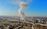 A smoke plume billows following a reported Syrian government air strike on a residential district of Maaret al-Numan in the northwestern Idlib province on December 18, 2019. (Omar HAJ KADOUR / AFP)