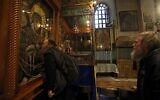 A Christian pilgrim kisses an icon of the Virgin Mary in the Church of the Nativity, the site where Christians believe Jesus was born, in the West Bank city of Bethlehem on December 18, 2019. (Musa Al Shaer/AFP)
