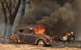An old car burns from bushfires in Balmoral, 150 kilometres southwest of Sydney on December 19, 2019. (PETER PARKS/AFP)