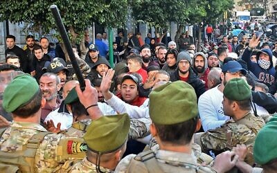 Supporters of outgoing Lebanese premier Saad Hariri clash with army soldiers during a protest in Beirut's Corniche al-Mazraa neighborhood on December 20, 2019. (AFP)