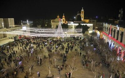Tourists and pilgrims visit the Manger Square outside the Church of the Nativity in the biblical West Bank city of Bethlehem on December 24, 2019. (HAZEM BADER / AFP)