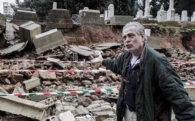 Nagi Georges Zeidan, an expert on the Jewish community in Lebanon and a volunteer at Jewish cemetery in the capital Beirut, inspects the site after several graves were damaged during bad weather in a winter storm on December 26, 2019. (Anwar Amro/AFP)