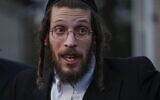 Josef Gluck talks to the press as he describes the machete attack that took place earlier outside a rabbi's home during the Jewish festival of Hanukkah in Monsey, New York, on December 29, 2019. (Photo by Kena Betancur / AFP)