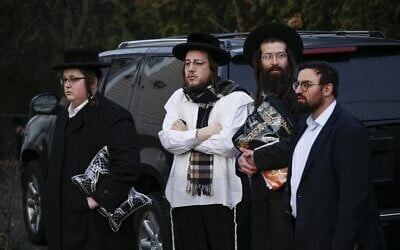 Members of the Jewish community gather outside the home of Rabbi Chaim Rottenberg in Monsey, in New York on December 29, 2019, after a machete attack that took place the night before inside the rabbi's home during the Jewish festival of Hanukkah. (Kena Betancur/AFP)
