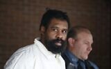 Suspect in Hanukkah celebration stabbings Grafton Thomas, 37, from Greenwood Lake,  leaves the Ramapo Town Hall in Airmont, New York after being arrested on December 29, 2019. (Kena Betancur/AFP)