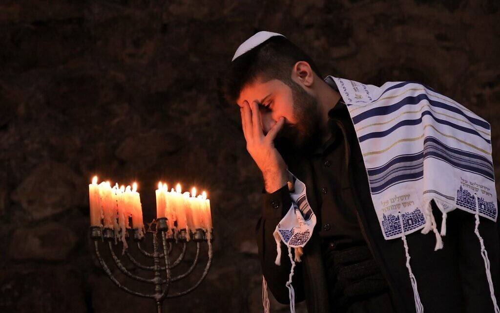 A member of Iraq's Kurdish Jewish community takes part in a ceremony on the last night of the Jewish holiday of Hanukkah in the Iraqi town of Al-Qosh, December 29, 2019. (SAFIN HAMED / AFP) A member of Iraq's Kurdish Jewish community takes part in a ceremony on the last night of the Jewish holiday of Hanukkah in the Iraqi town of Al-Qosh, December 29, 2019. (SAFIN HAMED / AFP)