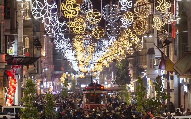 People walk past a historical tramway under Christmas light decorations on Istiklal street during preparations to celebrate the New Year 2020 in Istanbul on December 31, 2019. (Yasin Akgul/AFP) People walk past a historical tramway under Christmas light decorations on Istiklal street during preparations to celebrate the New Year 2020 in Istanbul on December 31, 2019. (Yasin Akgul/AFP)
