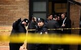 Illustrative: Police officers look at bullet holes in the windows of a school across the street from the JC kosher supermarket on December 11, 2019, in Jersey City, New Jersey. (Rick Loomis/Getty Images/AFP)