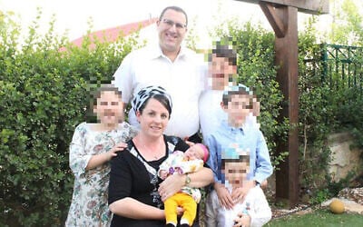 Noam (top middle) and Tzippi Rimel (middle), who is holding her daughter Noam in a family photo in November 2019. (Courtesy)