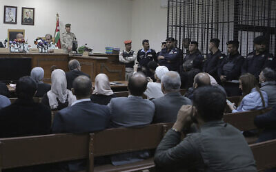 Israeli Konstantin Kotov stands in the defendant's cage during an appearance before a state security court where he was charged with illegally entering the country and possessing drugs, in Amman, Jordan, Monday Dec. 2, 2019. (AP Photo/Raad Adayleh)