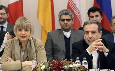 The European Union's political director Helga Schmid (L) and Iran's deputy Foreign Minister Abbas Araghchi wait for a bilateral meeting as part of the closed-door nuclear talks with Iran in Vienna, Austria, Friday, Dec. 6, 2019. (AP Photo/Ronald Zak)