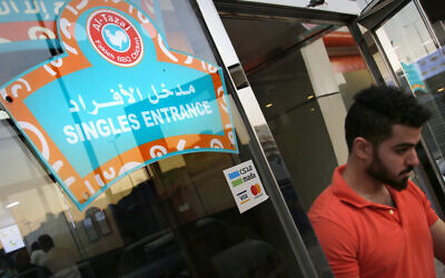 A mean leaves the singles entrance at a restaurant in Jiddah, Saudi Arabia, December 8, 2019. (AP Photo/Amr Nabil)
