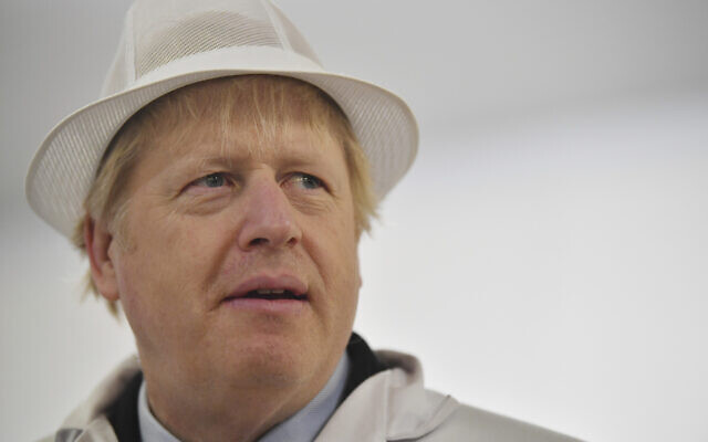 Britain's Prime Minister and Conservative Party leader Boris Johnson, center, visits Grimsby fish market in Grimsby, northeast England, Monday Dec. 9, 2019, ahead of the general election on Dec. 12. (Ben Stansall/Pool via AP) Britain's Prime Minister and Conservative Party leader Boris Johnson, center, visits Grimsby fish market in Grimsby, northeast England, Monday Dec. 9, 2019, ahead of the general election on Dec. 12. (Ben Stansall/Pool via AP)