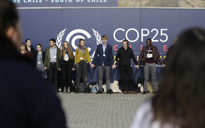Young activists from the 'Fridays For Future' climate protest Movement form a human chain at the COP25 Climate summit in Madrid, Spain, December 9, 2019. (Andrea Comas/AP)