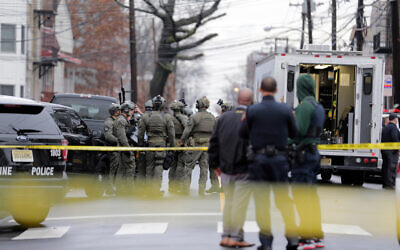 Illustrative: Police officers gather near the scene of a shooting, December 10, 2019, in Jersey City, New Jersey. (AP Photo/Seth Wenig)