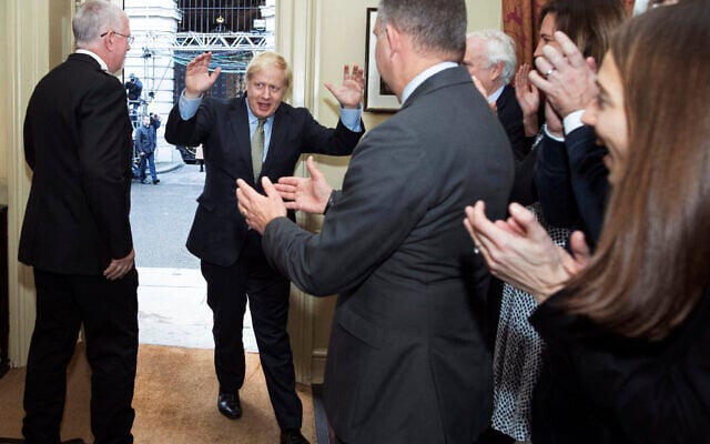 Britain's Prime Minister Boris Johnson is greeted by staff as he returns to 10 Downing Street, London, after meeting Queen Elizabeth II at Buckingham Palace and accepting her invitation to form a new government, Friday Dec. 13, 2019. Boris Johnson led his Conservative Party to a landslide victory in Britain’s election that was dominated by Brexit. (Stefan Rousseau/PA via AP) Britain's Prime Minister Boris Johnson is greeted by staff as he returns to 10 Downing Street, London, after meeting Queen Elizabeth II at Buckingham Palace and accepting her invitation to form a new government, Friday Dec. 13, 2019. Boris Johnson led his Conservative Party to a landslide victory in Britain’s election that was dominated by Brexit. (Stefan Rousseau/PA via AP)