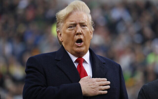 US President Donald Trump holds his hand over his heart for the Pledge of Allegiance before the start of the Army-Navy college football game in Philadelphia, Pennsylvania, December 14, 2019. (AP Photo/Jacquelyn Martin) US President Donald Trump holds his hand over his heart for the Pledge of Allegiance before the start of the Army-Navy college football game in Philadelphia, Pennsylvania, December 14, 2019. (AP Photo/Jacquelyn Martin)