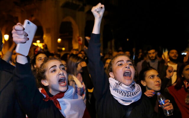 Protesters chant slogans during ongoing protests against the Lebanese political class, in downtown Beirut, Lebanon, December 22, 2019. (AP Photo/Bilal Hussein) Protesters chant slogans during ongoing protests against the Lebanese political class, in downtown Beirut, Lebanon, December 22, 2019. (AP Photo/Bilal Hussein)