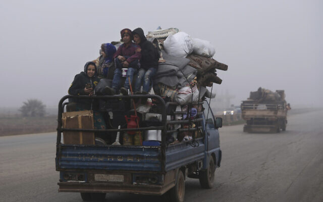Civilians ride in a truck as they flee Maaret al-Numan, Syria, ahead of a government offensive, December 23, 2019. (Ghaith al-Sayed/AP) Civilians ride in a truck as they flee Maaret al-Numan, Syria, ahead of a government offensive, December 23, 2019. (Ghaith al-Sayed/AP)