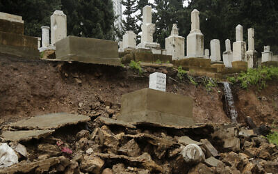 Graves from a Jewish cemetery lie on a sidewalk after it collapsed following heavy rains in the Sodeco area of Beirut, Lebanon, December 26, 2019. (AP Photo/Hassan Ammar)