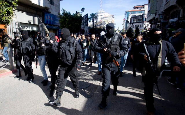 Masked Palestinians carry weapons during a celebration marking the 55th anniversary of the Fatah movement, in the West Bank city of Ramallah, December 31, 2019. (AP Photo/Majdi Mohammed) Masked Palestinians carry weapons during a celebration marking the 55th anniversary of the Fatah movement, in the West Bank city of Ramallah, December 31, 2019. (AP Photo/Majdi Mohammed)