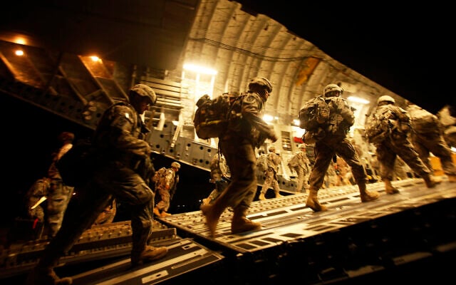 Illustrative: US Army soldiers from 2nd Brigade, 10th Mountain Division board a C-17 aircraft at Baghdad International Airport as they begin their journey to the United States, on July 13, 2010. (Maya Alleruzzo/ AP/ File) Illustrative: US Army soldiers from 2nd Brigade, 10th Mountain Division board a C-17 aircraft at Baghdad International Airport as they begin their journey to the United States, on July 13, 2010. (Maya Alleruzzo/ AP/ File)