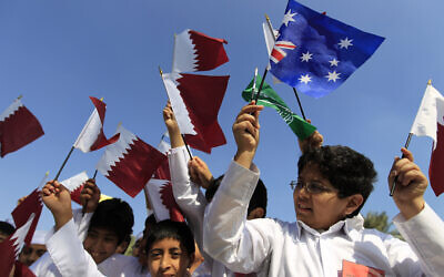 Illustrative -- Qatari school children wave their national flag and pendants of other Asian Cup soccer tournament teams in Doha, Qatar, Jan. 3, 2011 (AP Photo/Hassan Ammar)