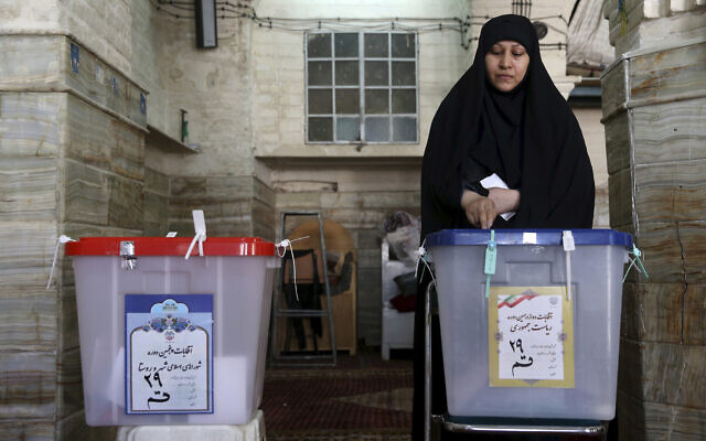 An Iranian voter casts her ballot during the 2017 presidential and municipal council election at a polling station in the city of Qom, 78 miles (125 kilometers) south of the capital Tehran, Iran, May 19, 2017. (AP Photo/Ebrahim Noroozi) An Iranian voter casts her ballot during the 2017 presidential and municipal council election at a polling station in the city of Qom, 78 miles (125 kilometers) south of the capital Tehran, Iran, May 19, 2017. (AP Photo/Ebrahim Noroozi)