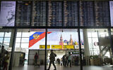 Illustrative: Passengers walk past a departure board at Sheremetyevo international airport in Moscow, Russia, July 8, 2019. (AP Photo/Pavel Golovkin)