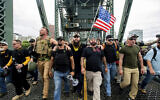 Illustrative: Members of the Proud Boys and other US right-wing demonstrators march across the Hawthorne Bridge during an 'End Domestic Terrorism' rally in Portland, Oregon, on August 17, 2019. (AP Photo/Noah Berger)