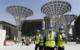 In this photo from October 8, 2019, technicians walk at the three thematic districts at the under construction site of the Expo 2020 in Dubai, United Arab Emirates. (AP Photo/Kamran Jebreili)