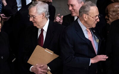 In this photo from October 24, 2019, Senate Majority Leader Mitch McConnell talks with House Speaker Nancy Pelosi, not seen, as Senate Minority Leader Chuck Schumer, right, talks with House Minority Leader Kevin McCarthy, not seen, before a memorial service for Democratic Representative Elijah Cummings of Maryland, at the Capitol in Washington. (Erin Schaff/Pool via AP)