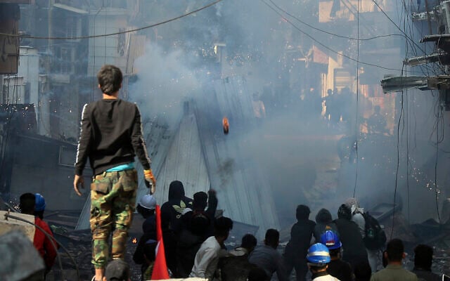 Riot police fire tear gas during clashes with anti-government demonstrators in Baghdad, Iraq, Saturday, Nov. 30, 2019. (AP/Hadi Mizban) Riot police fire tear gas during clashes with anti-government demonstrators in Baghdad, Iraq, Saturday, Nov. 30, 2019. (AP/Hadi Mizban)