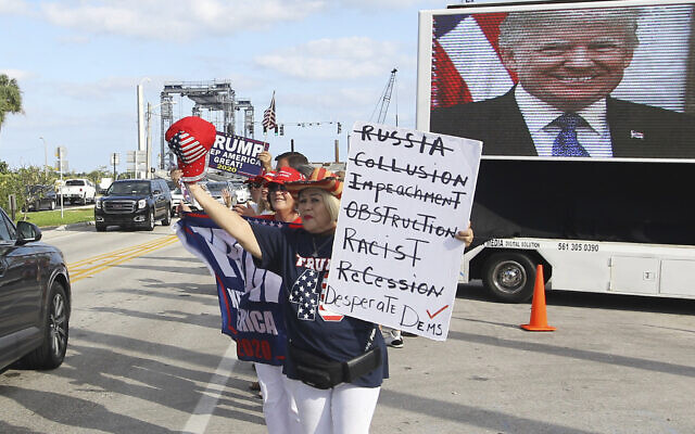 Supporters wait to see the motorcade carrying US President Donald Trump on his way to Mar-a-Largo in West Palm Beach, Fla., Sunday, Dec. 1, 2019. (AP Photo/Luis M. Alvarez)
