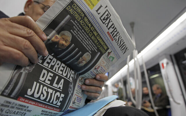 A man reads a newspaper headlining on the trial of two former Algerian prime ministers, Ahmed Ouyahia and Abdelmalek Sellal, in Algiers December 2, 2019. (Fateh Guidoum) A man reads a newspaper headlining on the trial of two former Algerian prime ministers, Ahmed Ouyahia and Abdelmalek Sellal, in Algiers December 2, 2019. (Fateh Guidoum)